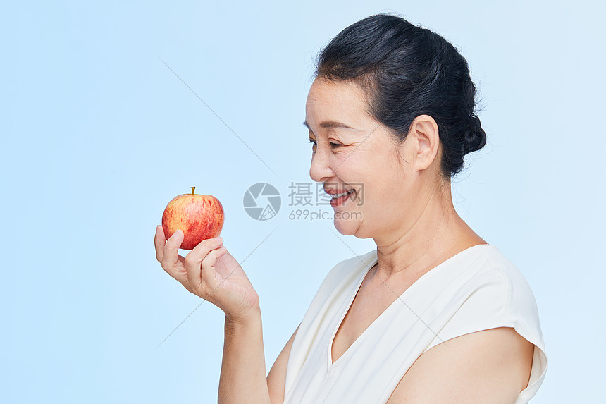 老年女性手拿苹果图片
