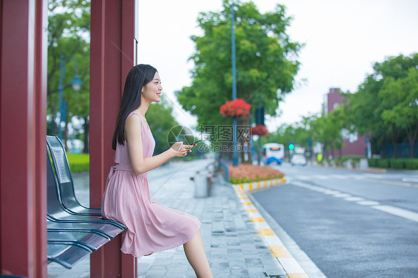 在公交车站台等待的青年女性图片