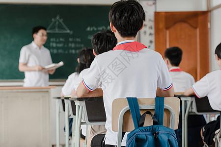 小学生在写作业教师在给学生上课背景