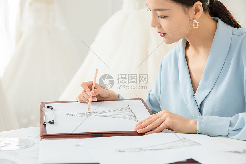 绘画设计图的服装设计师特写图片