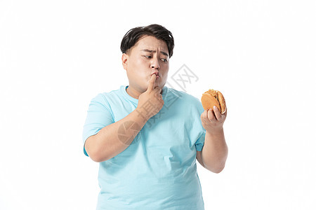 肥胖男士犹豫要不要吃汉堡背景图片