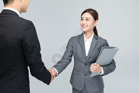 与客户握手合作的商务女性背景图片