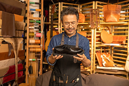 中年男性鞋匠手工定制皮鞋背景图片