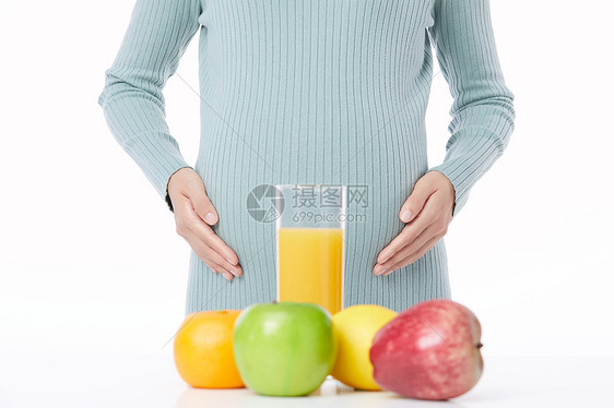 健康水果和孕妇肚子近景图片