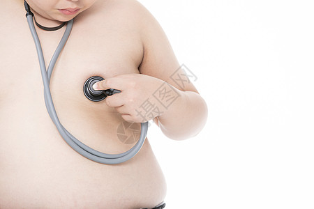 拿着用听诊器检查心脏的男孩小胖子图片