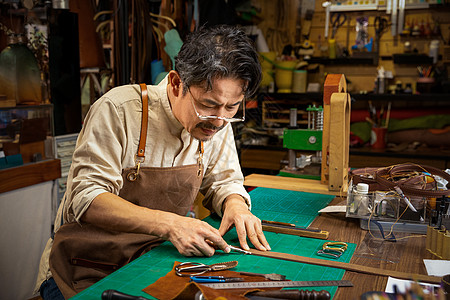 男性工匠手工制作皮带图片