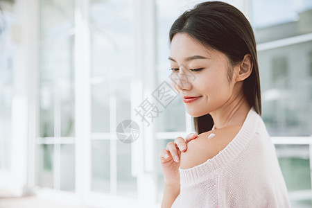 露肩美女独居生活秋冬保湿护肤擦身体乳背景图片