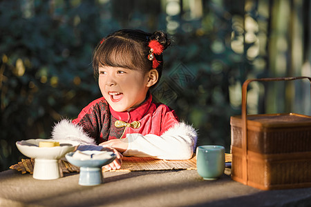 中国传统汉服可爱儿童公园吃点心图片