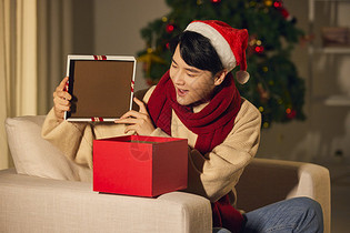 年轻男士圣诞节打开礼物盒惊喜表情图片