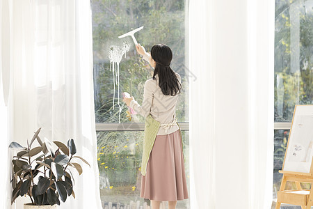 清洁玻璃窗的居家女性图片