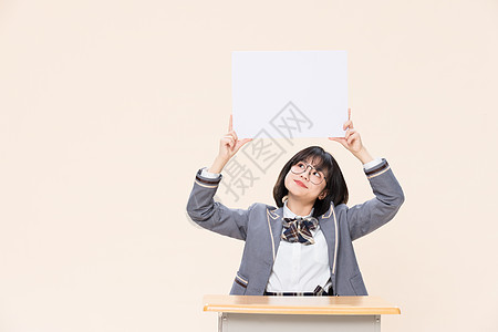 女性海报坐在课桌前展示白板的青春大学生背景