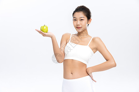 塑形塑身美女手拿苹果饮食管理背景图片
