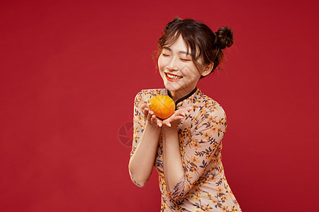 苹果橙子中国风国潮旗袍美女拿橙子背景