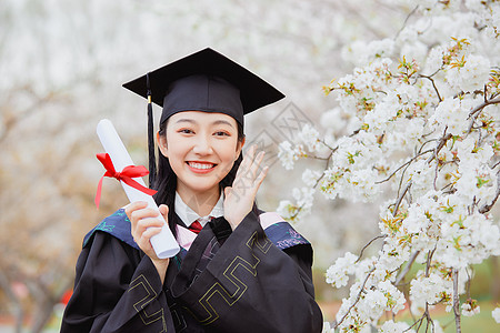 穿着学士服女孩女大学生公园花季毕业照背景