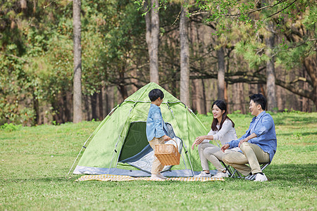 妈妈儿子一家三口公园里郊游过周末背景