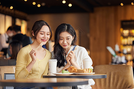 坐在店里聚会聊天的闺蜜二人图片