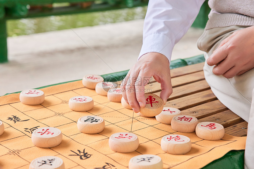 父子公园湖边下象棋手部特写图片