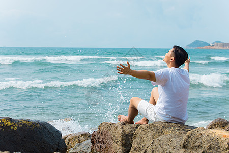 海岛旅游男孩青年男性张开手臂拥抱大海背影背景