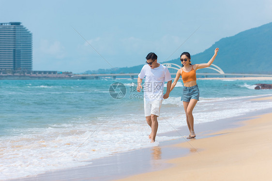 夏日情侣海边沙滩上嬉戏戏水图片