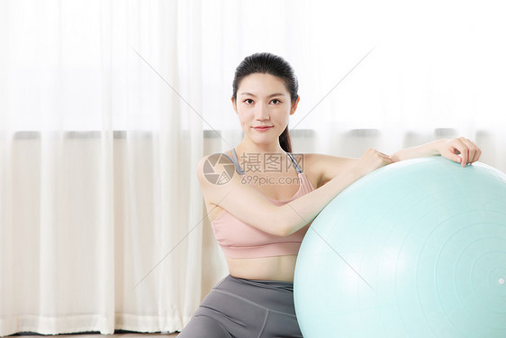 瑜伽美女在瑜伽球上休息图片