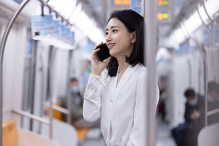 地铁上打电话的女性图片