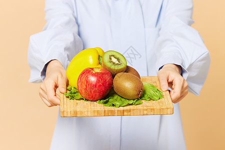 营养科学女营养师饮食推荐手托水果特写背景