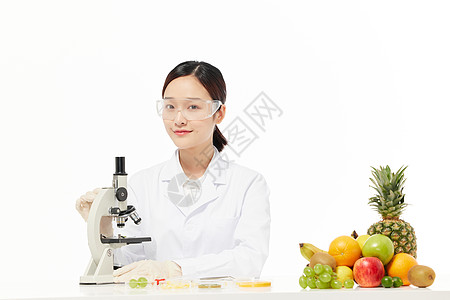 营养学家用显微镜检测水果样本背景图片