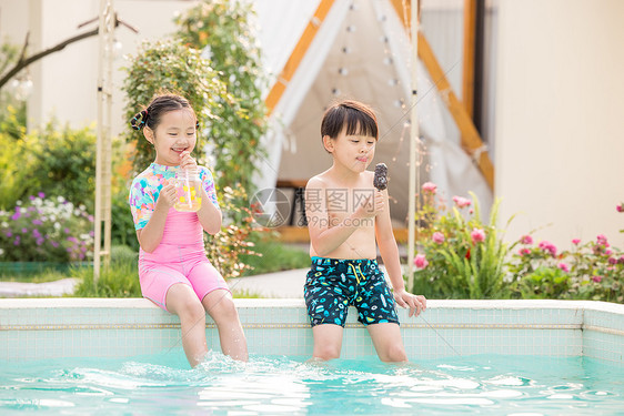 小男孩小女孩坐在泳池开心玩耍图片