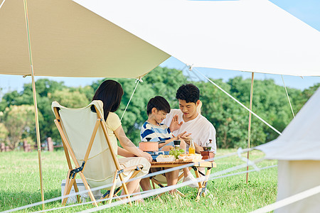 一家三口郊游一家人夏日户外露营背景