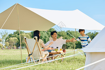 一家三口郊游一家人夏日户外露营背景