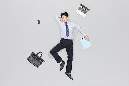 文件包创意俯拍商务男性职场躺着休息背景