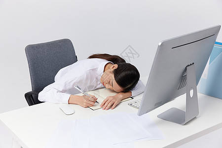 工作压力工作趴在桌子上疲惫的职场女性背景