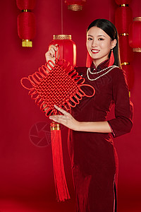 拿着灯笼女人拿着中国结微笑的穿旗袍女子背景