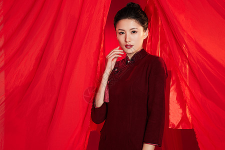 中国红丝绸红色飘带背景中的旗袍美女形象背景