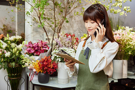 花店美女服务员接电话咨询背景图片