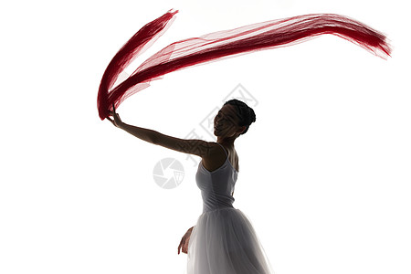 丝带舞者剪影拿着红色丝带跳舞的女性剪影背景