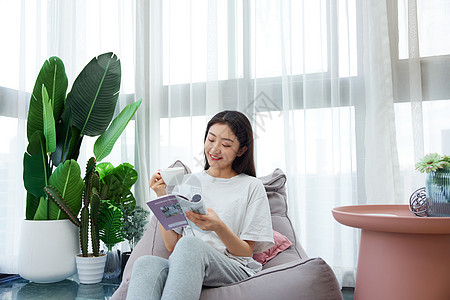 女性休闲居家生活阳台上看书喝咖啡图片