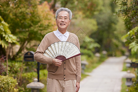 老年人小区散步欣赏花草图片