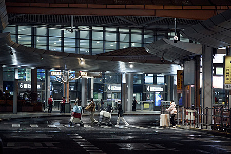 城市夜晚机场行走穿梭的人们高清图片