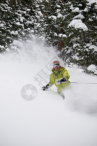 滑雪者沿雪坡滑行图片