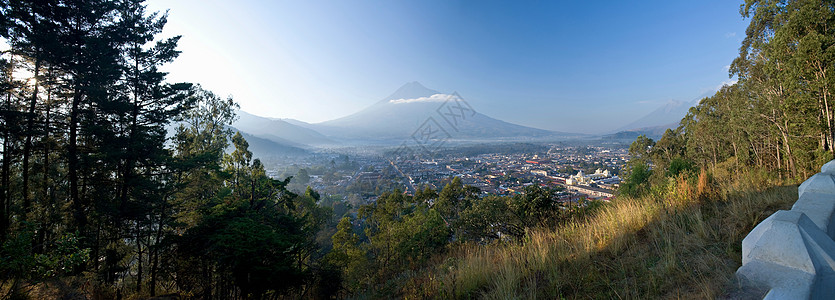 青草山坡俯瞰城市图片