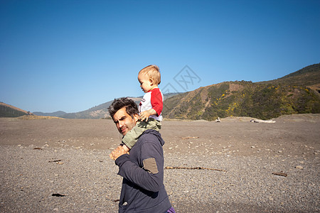 背小孩沙漠中父亲肩上背的儿子背景