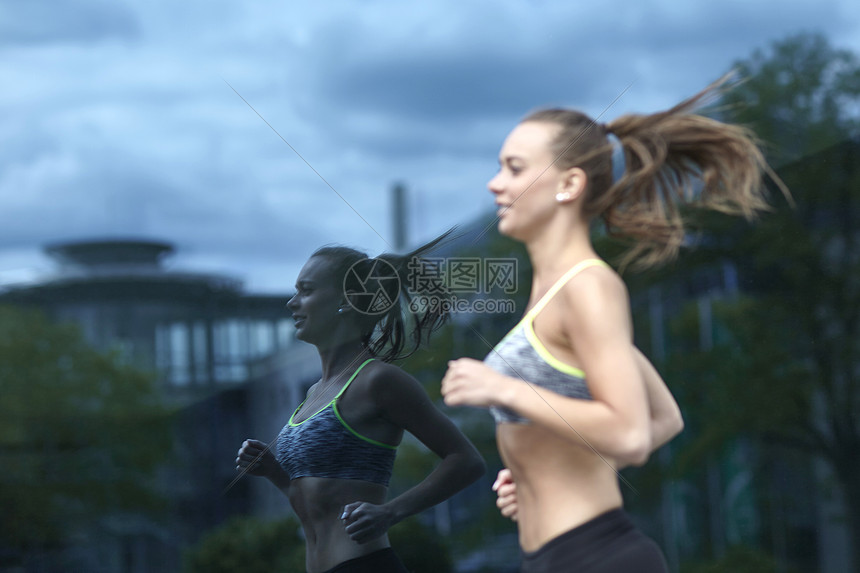 在办公楼前跑步的女子图片