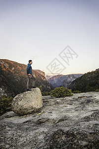 美国加利福尼亚州约塞米特公园里站在巨石上远望的男人图片