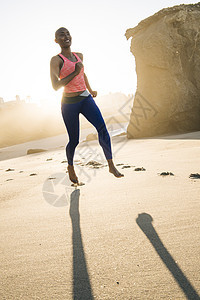 年轻女子在海滩上运动跑步图片