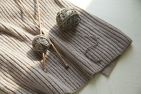阳光下的针织围巾成品与毛线球图片