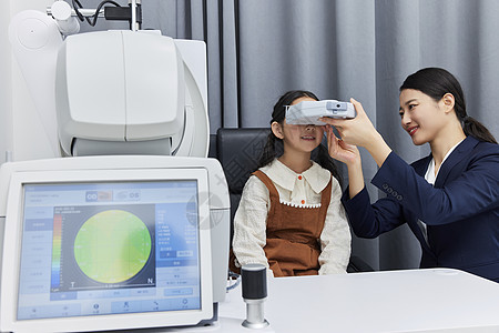 验光师用专业验光仪器给小女孩检查视力图片