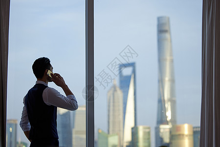 看城市风景打电话的商务人士背影高清图片