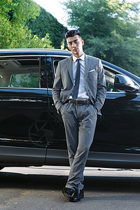 青年男人站在汽车旁边图片