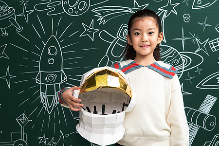 小学插画抱着航天员头盔的小女孩站在黑板前背景